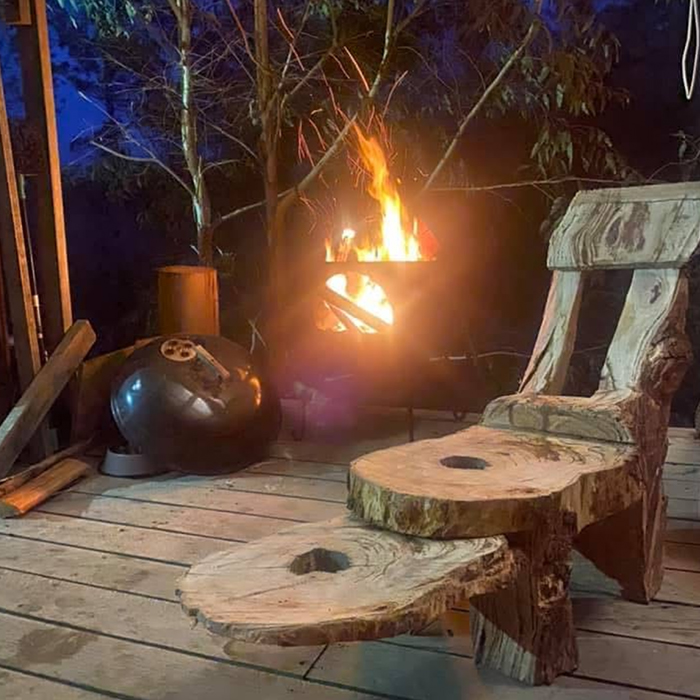 Timber stools crafted from tree stumps in a cleared forest setting